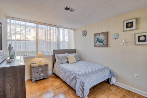 a bedroom with a bed and a large window