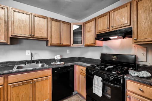 a kitchen with black appliances and wooden cabinets