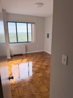 A room with a window and a radiator on the wall.