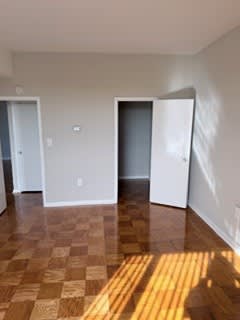 A room with a checkered floor and three doors.