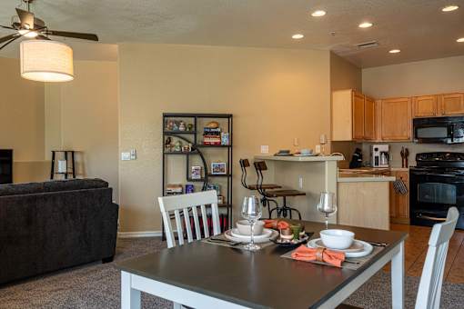 A modern dining room with a table set for two.