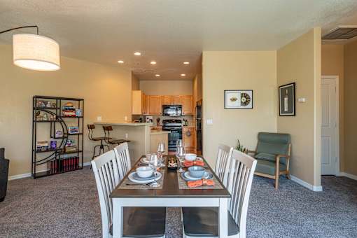 A dining room with a table set for two.