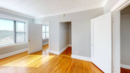 A room with wooden floors and white walls.