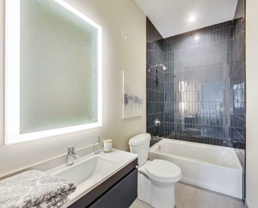 a bathroom with a toilet and a tub and a sink