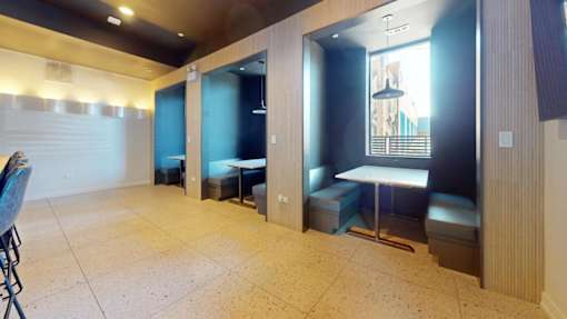 a public restroom with tables and benches and a blue wall