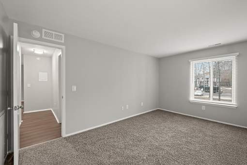 A room with a window and a door.