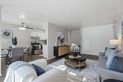 A modern living room with a grey sofa and a coffee table.