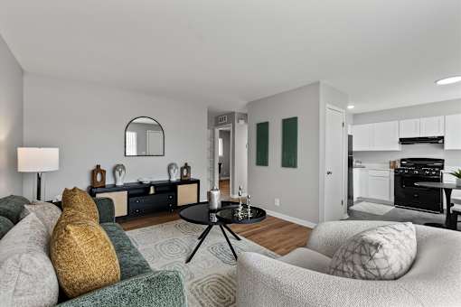 A living room with a grey couch and a black coffee table.