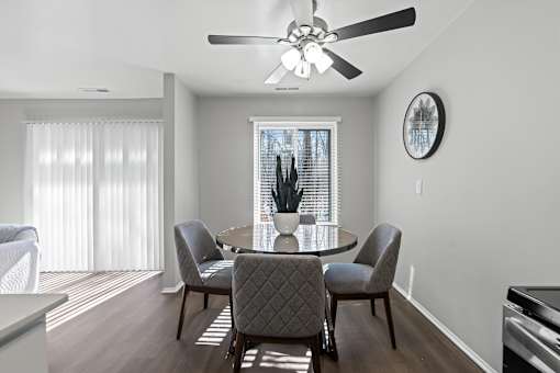A dining room with a table and chairs.