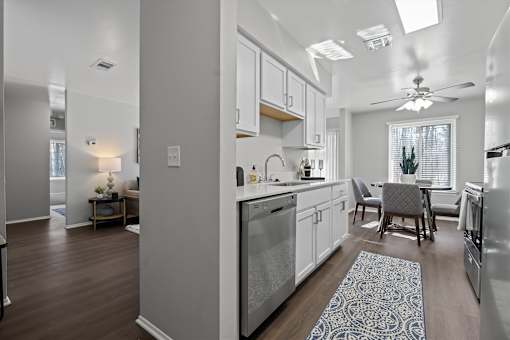 A modern kitchen with a dining area and a living room.