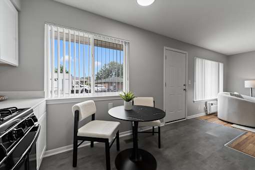 A modern kitchen with a black table and white chairs.
