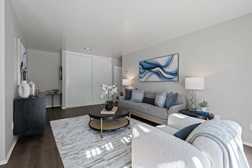 A modern living room with a grey sofa and a coffee table.