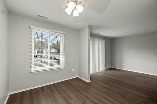 A room with a window and a ceiling fan.