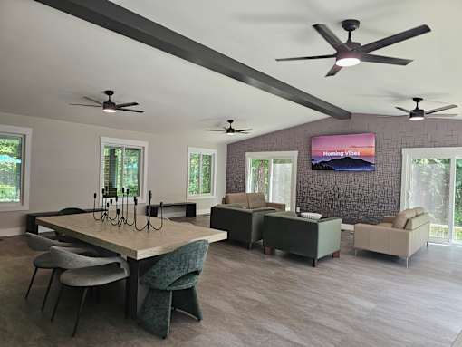 A modern living room with a large table and chairs.