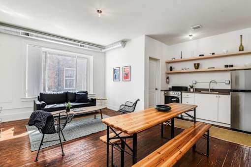 A kitchen with a table and chairs in the middle of the room.