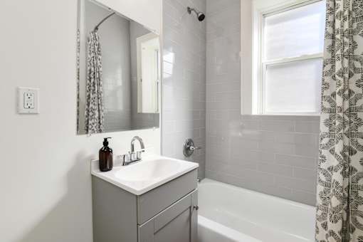 A white sink with a brown bottle on top of it.