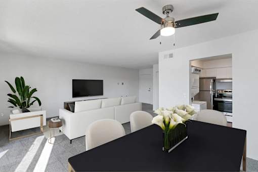 A black table with a vase of white flowers on it.