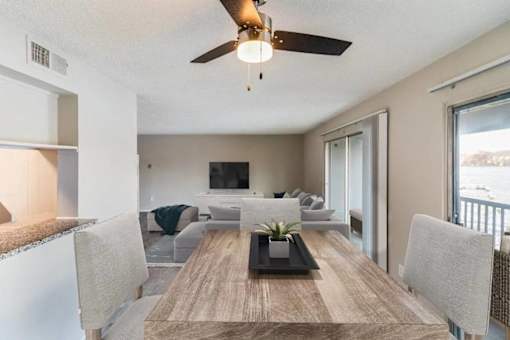 A modern dining room with a wooden table and chairs.