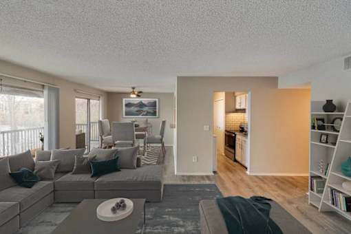 A living room with a grey couch and a coffee table.