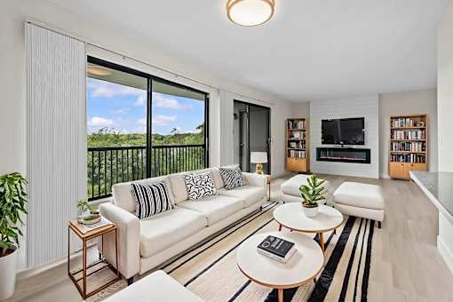 A living room with a white couch and a coffee table.