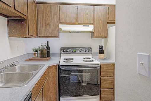A modern kitchen with wooden cabinets and stainless steel appliances.