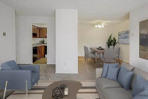 A living room with a grey couch and a blue chair.