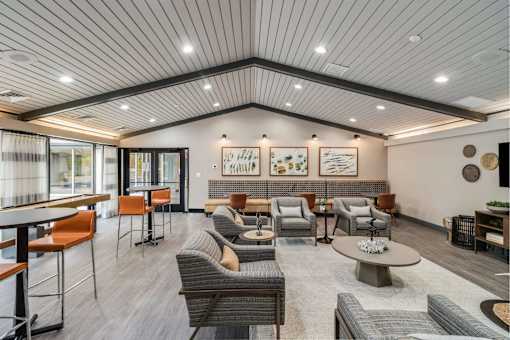 A spacious waiting area with a variety of seating options and artwork on the walls.