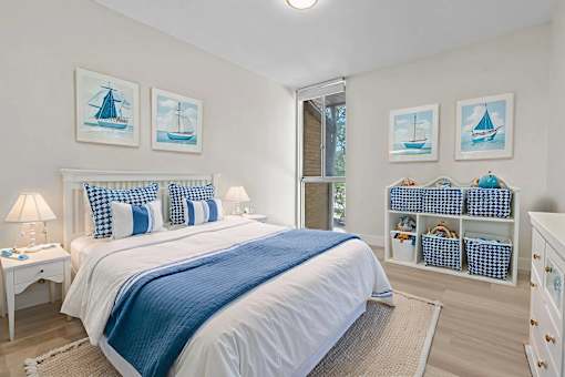 A bedroom with a white bed and blue accents.