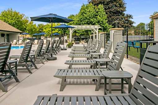 A poolside area with sun loungers and umbrellas.