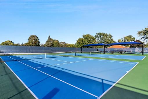 A tennis court with a blue surface and white lines.