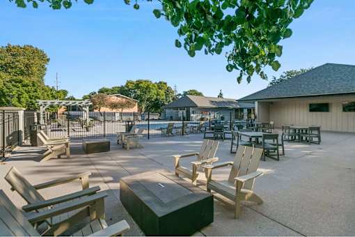 A sunny day at the park with wooden benches and picnic tables.