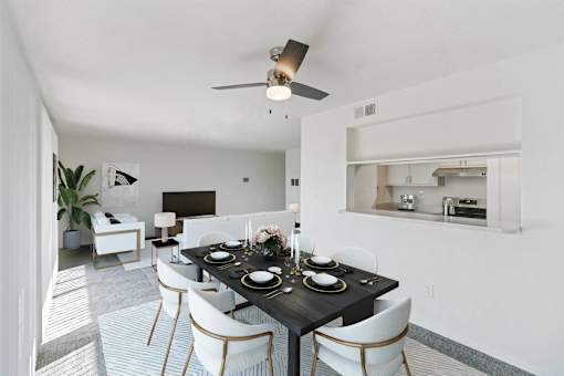 A dining room with a black table set for two.