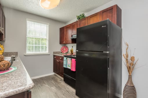 a kitchen with black appliances and wooden cabinets