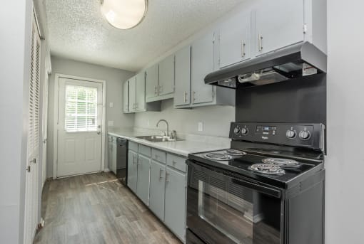 a kitchen with stainless steel appliances and white cabinets