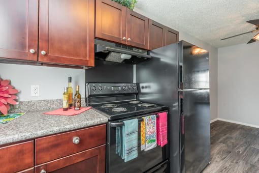 a kitchen with black appliances and a granite counter top