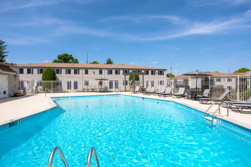a swimming pool with a building in the background