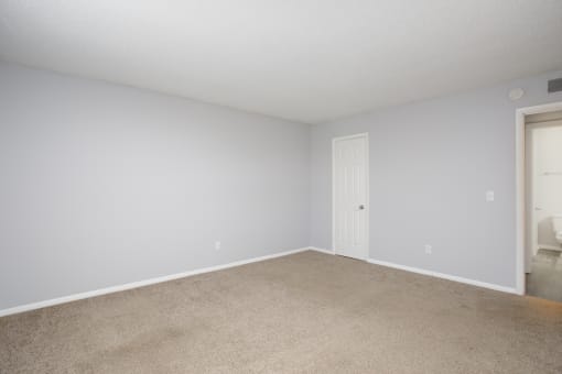 an empty room with white walls and a white door