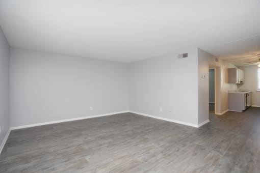a living room with white walls and wood flooring
