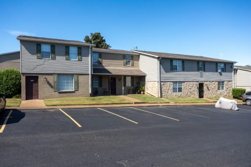 an apartment building with an empty parking lot