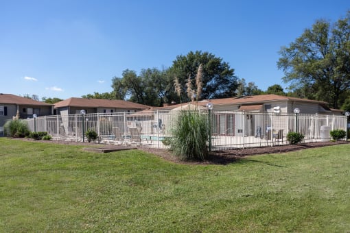 a home with a large yard and a white fence