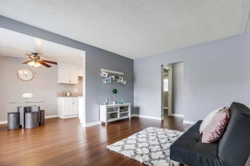 Apartments for Rent in West Covina CA - Tuscany Villas - Bedroom with Wood-Style Flooring, Mirrored Closet Door, Small Window, and Grey Walls