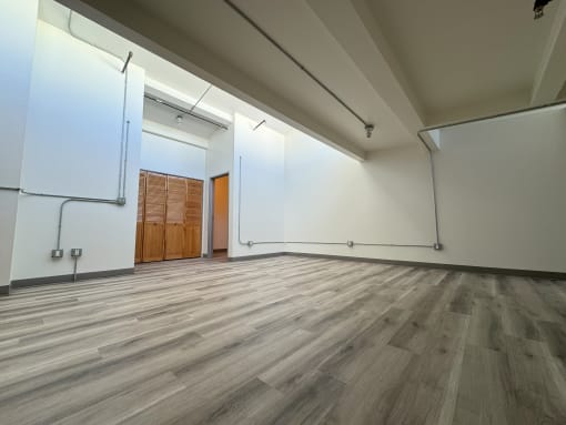 a large room with white walls and wood floors