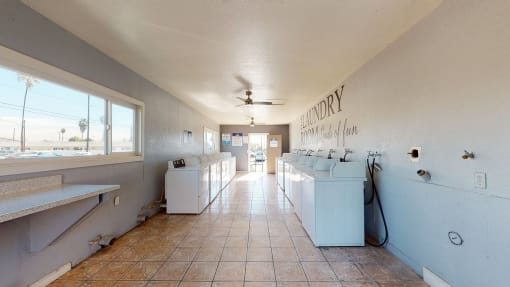 Apartments in Colton CA for Rent - Las Brisas Apartments Laundry Room with Washing Machines, Dryers, and A Folding Station