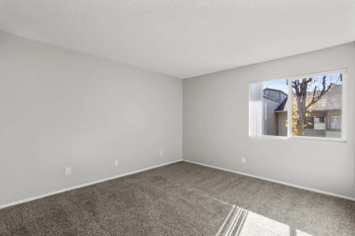 an empty bedroom with a large window at Aspire Rialto, California