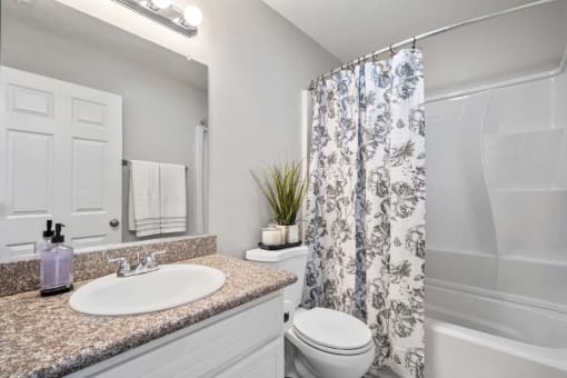 a bathroom with a sink toilet and shower at Aspire Rialto, Rialto California