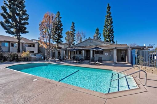 a swimming pool with a house in the background at Aspire Rialto, Rialto, CA 92376