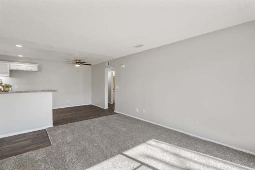 an empty living room with a kitchen in the background at Aspire Rialto, California, 92376