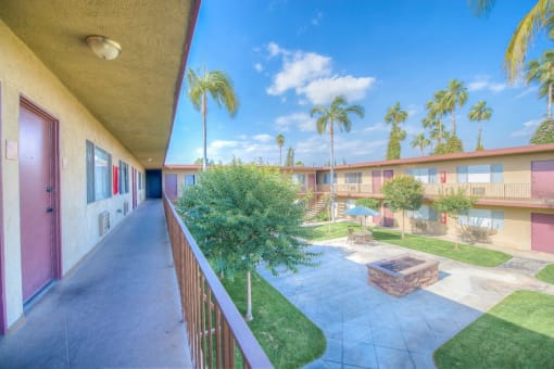 West Covina Apartments for Rent - Courtyard with Lush Landscaping and Walkways Surrounded by Tuscany Villas Apartment Buildings