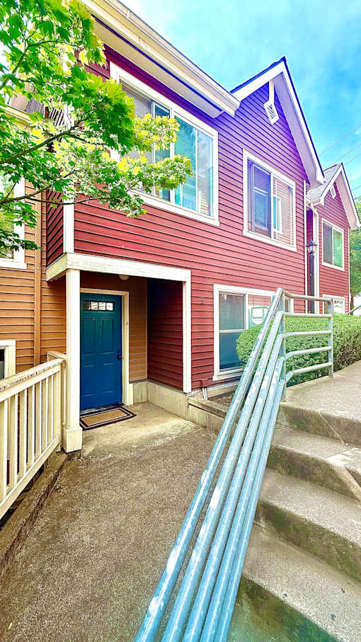 A house with a blue door and a red siding.