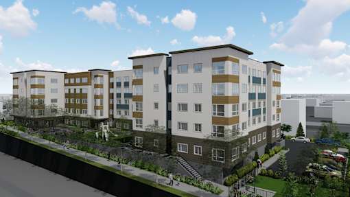 A modern apartment complex with multiple buildings and a parking lot in front.
